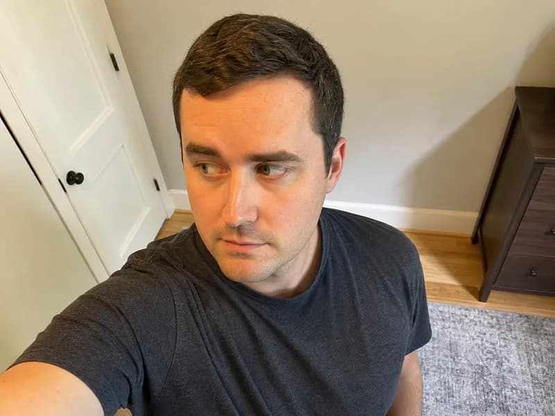 A selfie shot from above with the subject looking to the side — not allowed