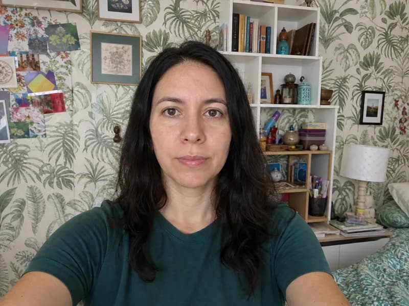 A selfie taken against a cluttered, busy wall — not allowed